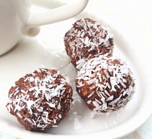 Three chocolate balls with shredded coconut