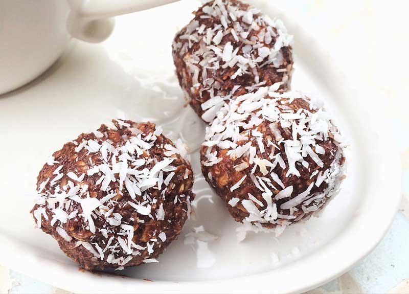 Three chocolate balls with shredded coconut